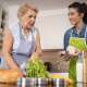 A senior woman prepares a healthy meal with the help of a caregiver who specializes in diabetes care at home.
